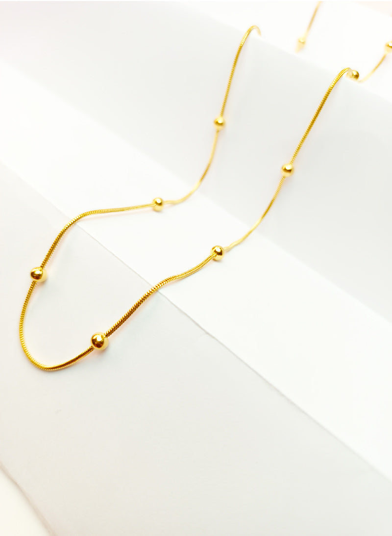 Long gold chain with gold beads