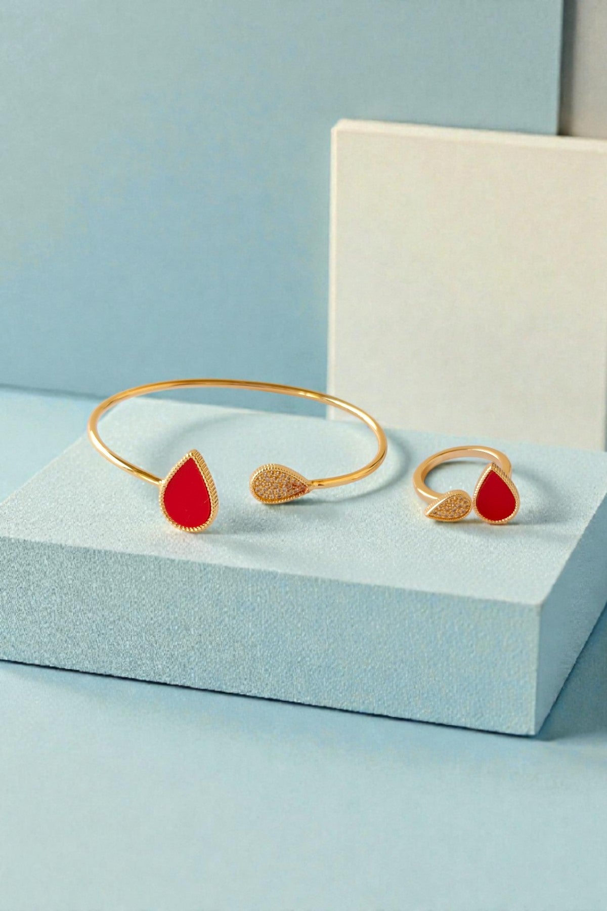 Gold bracelet and ring with red accents 